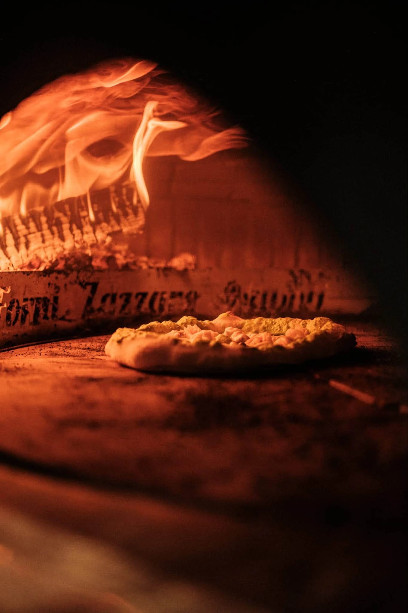 Une pizza dans le four à bois